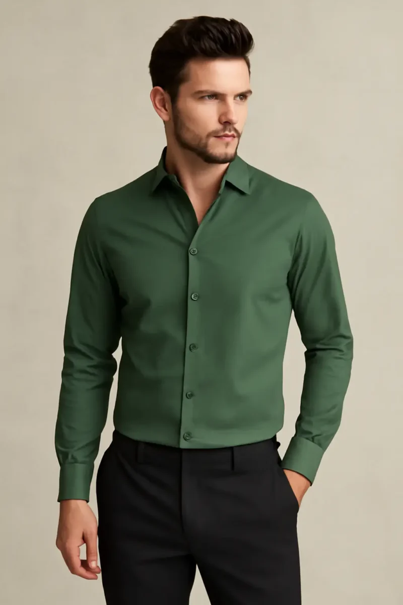 Man wearing a solid bottle green slim fit full-sleeve shirt with black formal trousers against a neutral background.