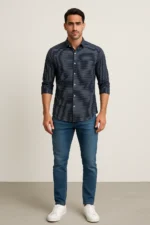 Man wearing a navy blue slim fit full-sleeve shirt with horizontal stripes, paired with blue jeans and white sneakers.